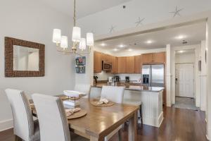 a kitchen and dining room with a wooden table and chairs at Blue Mtn Beach - Red Vill 219 in Santa Rosa Beach