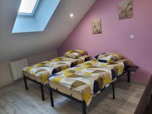 two beds in a room with a attic at O Bel Haybois Dormant " Le Cerf " in Haybes