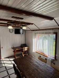 a room with a table and a desk and a clock at Живописні карпати in Slavske +38 photos