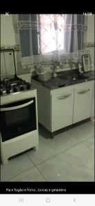 a kitchen with a stove and a white oven at Casa cataratas 3 in Foz do Iguaçu