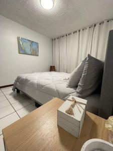 a bedroom with a bed and a coffee table with a table sidx sidx at Lovely 2 bedroom condo 2min walking to the beach in Monserrate