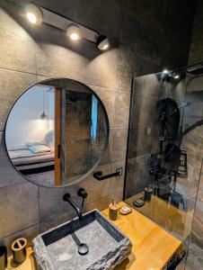 a bathroom with a sink and a mirror at Casa din padure in Orşova +17 photos