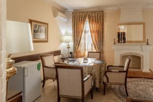 a living room with a table and chairs and a fireplace at SAMIR HOTEL in Yakkasaray