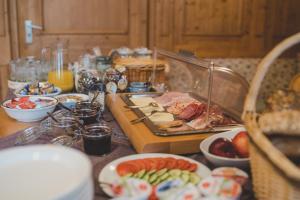 a table topped with plates of food and fruit at Hotel Adler in Nattheim