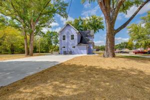 a house with a tree in front of a driveway at Walk to Winery Family-Friendly Holt Getaway in Kearney