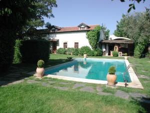 a swimming pool in the yard of a house at Casa da Quinta De S. Martinho in Vila Real