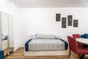 a bedroom with a bed and a table and chairs at Wise Nest Studio in Sinaia