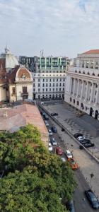 a city street with cars parked in a parking lot at Old Town Studio in Bucharest