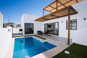 a swimming pool in the backyard of a house at Exclusive pool house in Bahía Kino