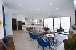 a living room with a couch and a table and chairs at Exclusive pool house in Bahía Kino