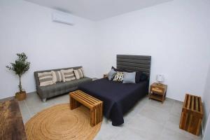 a living room with a couch and a coffee table at Exclusive pool house in Bahía Kino +31 photos