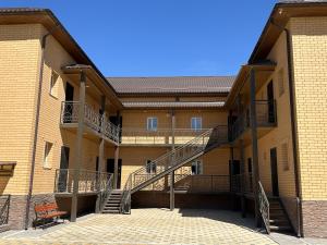 an exterior view of a building with a staircase at Tolqyn apart hotel in Aktau