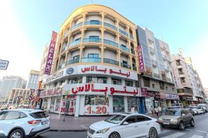 a large building with cars parked in front of it at City Relax Hotel in Dubai +23 photos