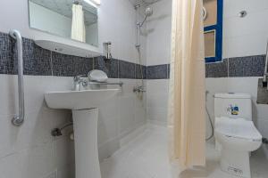 a bathroom with a sink and a toilet at City Relax Hotel in Dubai