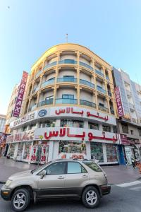 a car parked in front of a large building at City Relax Hotel in Dubai
