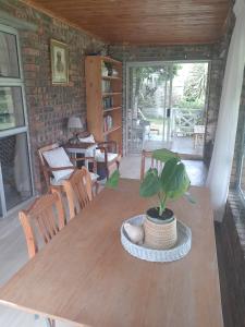 a wooden table with a potted plant on top of it at Sea Cottage in Noordhoek
