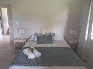 a bedroom with two beds with towels on them at Sea Cottage in Noordhoek