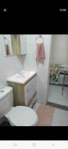 a bathroom with a toilet and a sink and a shower at Casa cataratas 3 in Foz do Iguaçu
