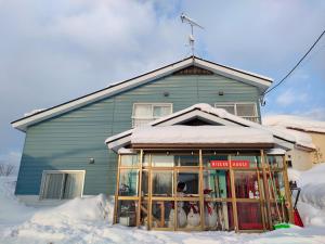 a house with snow on the ground in front of it at TR Niseko House Room Sky in Niseko