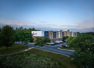 an aerial view of a building with a parking lot at Candlewood Suites Milwaukee Airport - Oak Creek by IHG in Greendale