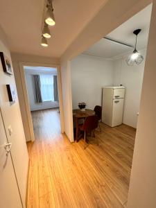 a living room with a table and a refrigerator at Tallinn Downtown 1BR apartment with parking in Tallinn