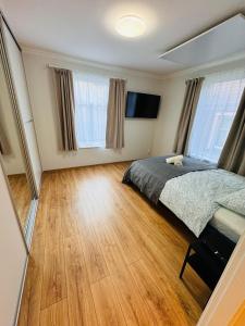 a bedroom with a bed and a wooden floor at Tallinn Downtown 1BR apartment with parking in Tallinn