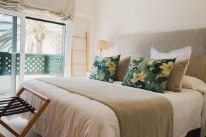 a bedroom with a large bed and a window at CASA ESPERANZA *Family Home Over the Sea* in Telde