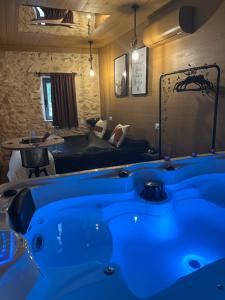 a blue bath tub in a room with a bed at Mas Xalmes in Camarles