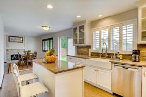 a kitchen with white cabinets and a large island at Washington Retreat with Yard - Near Seattle! in Marysville