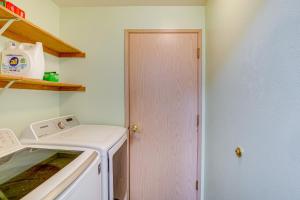 a kitchen with a white stove top oven next to a door at Washington Retreat with Yard - Near Seattle! in Marysville +24 photos