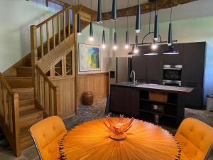 a dining room with a table and a staircase at Garden Cottage Kervolongar in Garlan