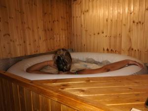 a woman is laying in a bath tub at Casa Valle del Hontanar in Cardenete +38 photos