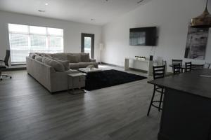 a living room with a couch and a table at Hideaway in a Luxurious Location in Saint Robert