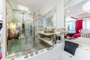 a bathroom with a shower and a tub with a sink at Le Rubis - Love Room Romantique in Juvisy-sur-Orge