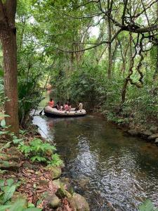 a group of people in a boat on a river at Ranpokuna Bungalow with 3 Bed Rooms in Kiriella +8 photos
