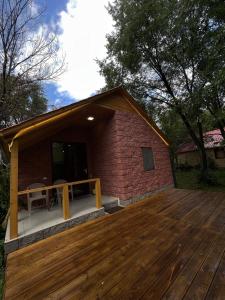 a house with a deck with a table on it at Forest Home in Sevan