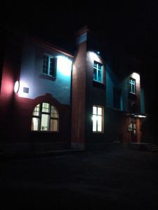 a building with lights on the side of it at night at Hotel Britz in Velké Hamry