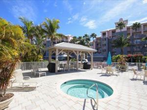 a swimming pool with a gazebo and chairs and a pavilion at Boca Vista - Unit B202 in Englewood