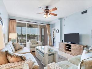 a living room with a couch and a flat screen tv at Boca Vista - Unit B202 in Englewood