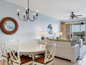 a dining room and living room with a table and chairs at Boca Vista - Unit B202 in Englewood
