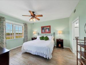 a bedroom with a bed and a ceiling fan at Boca Vista - Unit B202 in Englewood +19 photos