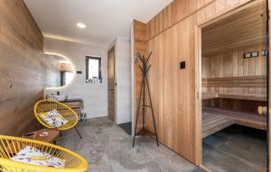 a room with two chairs and a sauna at Cozy Apartment In Drage With Sauna in Drage