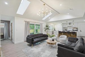 a living room with two couches and a table at 3-BD Backyard Oasis w Pool Patio Firepit in Irving
