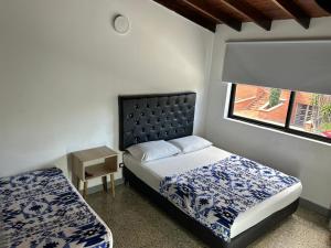 Postel nebo postele na pokoji v ubytování Hotel Urbano 70