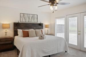 a bedroom with a bed with a ceiling fan at Your Rustic Retreat w Backyard Oasis Pool Patio in Keller