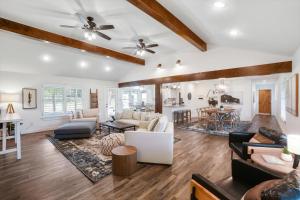 a living room with white walls and wooden ceilings at Your Rustic Retreat w Backyard Oasis Pool Patio in Keller
