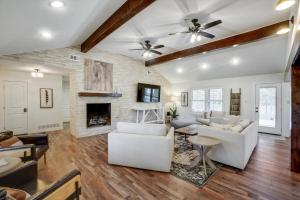 a living room with white furniture and a fireplace at Your Rustic Retreat w Backyard Oasis Pool Patio in Keller +46 photos