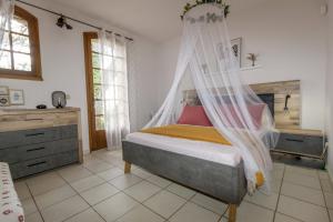 a bedroom with a bed with a mosquito net at Villa Ceyreste in Ceyreste +75 photos