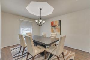 a dining room with a black table and chairs at Spacious and Modern Home with Private Pool in Plano