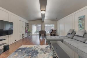 a living room with a couch and a television at Spacious and Modern Home with Private Pool in Plano